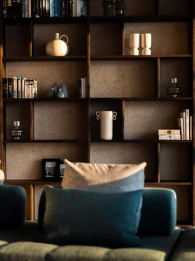 Persönliche Stilanalyse Modernes Wohnzimmer mit grünem Sofa und Bücherregal bei Sonnenlicht